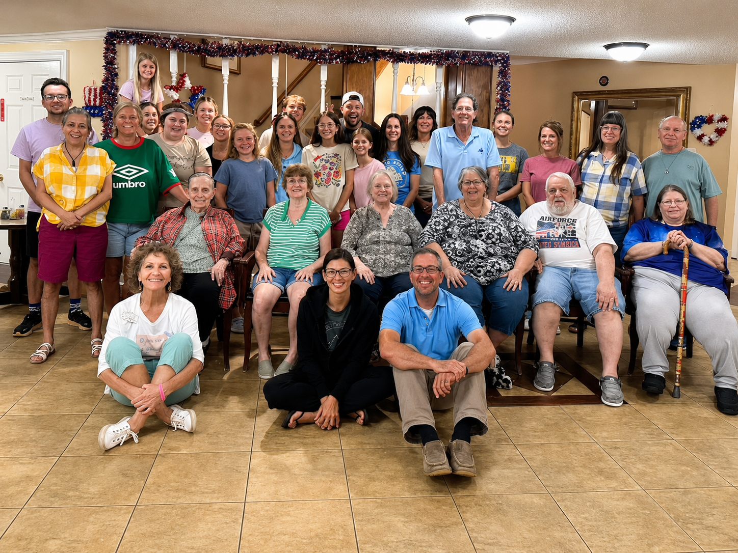 Residents, families and associates gathered on the lobby stairs for a community photograph